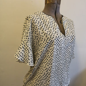 Francesca's white blouse with black polka dots